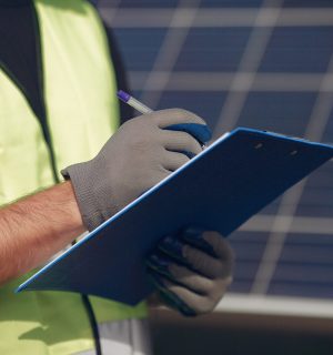 man-with-white-helmet-near-solar-panel-scaled